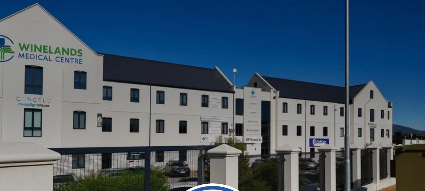 Winelands Medical Centre building at 1D New Eskdale Street, Paarl, with the Winelands Medical Centre sign on the facade under a clear blue sky