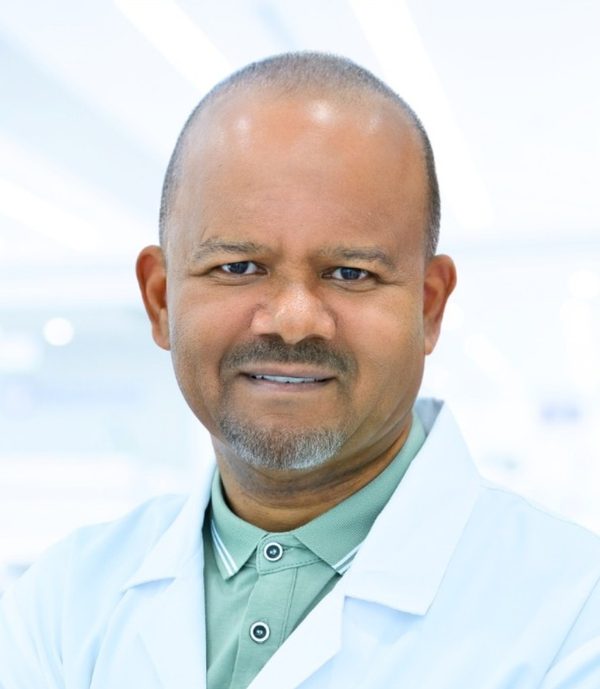 Dr Arthur Williams in a white coat at HealthPLUS